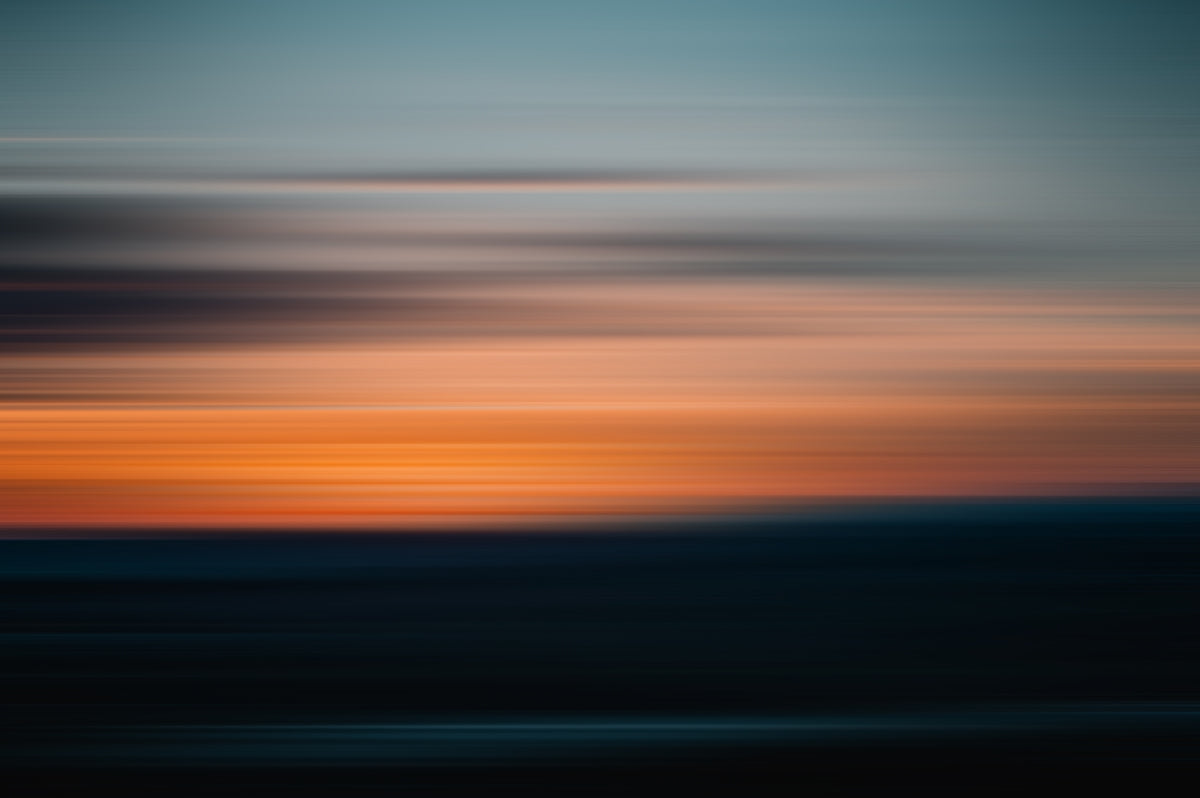 a blurry photo of a sunset with a sky in the background