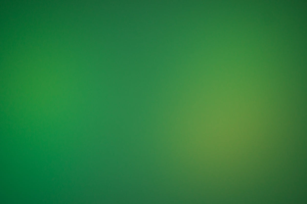 a blurry green background with a white border
