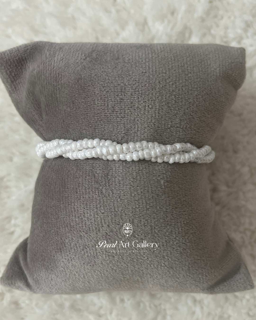 Divine Grace Beaded Rakhi – White Twist Chain with Hand Charm